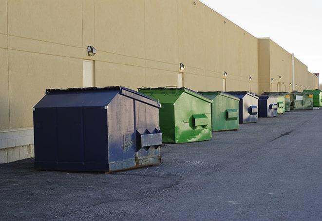 construction dumpsters stacked in a row on a job site in Harvest